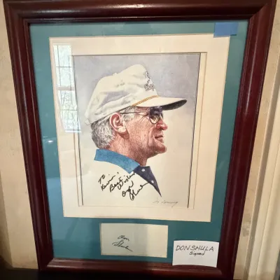 Sale Photo Thumbnail #219: Framed and matted portrait print of Miami Dolphins coach Don Shula, featuring a personalized autograph and housed in a cherry-finish wood frame.