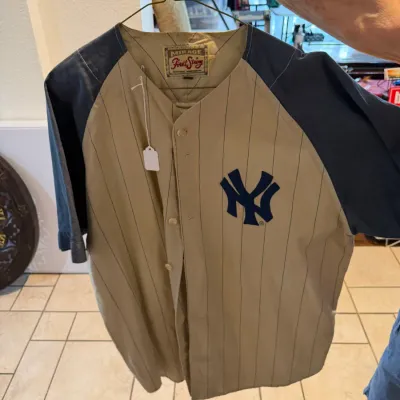 Sale Photo Thumbnail #35: Vintage Mirage First String New York Yankees pinstripe baseball jersey with navy blue raglan sleeves, button front, and stitched NY logo. (Front)