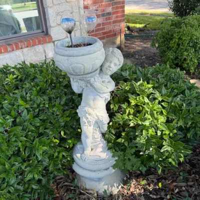 Sale Photo Thumbnail #284: Cast stone cherub garden planter statue, featuring a putto holding an urn vessel above its shoulder. (Fixable crack in pot)