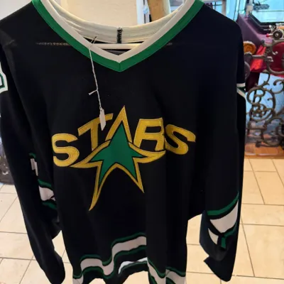Sale Photo Thumbnail #31: Vintage Dallas Stars NHL hockey jersey in black with green, gold, and white trim
