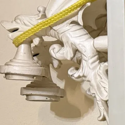 Sale Photo Thumbnail #331: Intricately detailed white painted cast metal gargoyle-style wall sconces featuring mythical winged dragon motifs and dual light sockets.