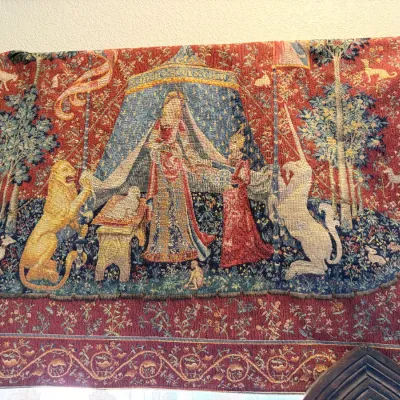 Sale Photo Thumbnail #164: Woven wall tapestry featuring a reproduction of 'The Lady and the Unicorn' motif on a red floral background.