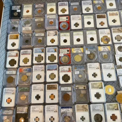 Sale Photo Thumbnail #59: Collection of professionally graded collectible coins displayed in slab holders