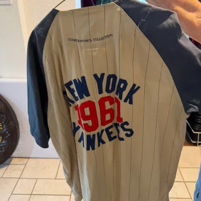 Sale Photo Thumbnail #36: Cooperstown Collection New York Yankees 1961 baseball jersey featuring a pinstriped beige body and navy raglan sleeves. (Back)