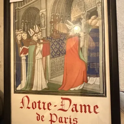 Sale Photo Thumbnail #233: Framed 1963 exhibition poster for 'Notre-Dame de Paris' at La Sainte-Chapelle, featuring medieval-style religious artwork in a simple black frame.