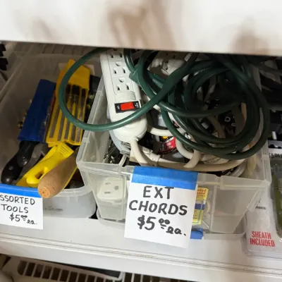 Sale Photo Thumbnail #317: Plastic bins containing assorted hand tools, power strips, and extension cords, priced individually.