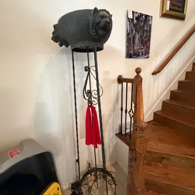 Sale Photo Thumbnail #28: Tall wrought iron plant stand or brazier featuring a dark metal basin adorned with carved lion head motifs. (Lighted)