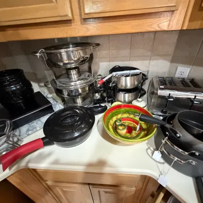 Sale Photo Thumbnail #254: Assorted kitchen appliances and cookware, including stainless steel chaffing dishes, a four-slot toaster, nonstick pots, and decorative nesting bowls.