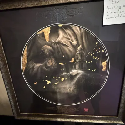 Sale Photo Thumbnail #223: Framed limited edition print titled 'She' by artist Yoann Lossel, featuring circular artwork with gold leaf accents in a metallic-finish frame.