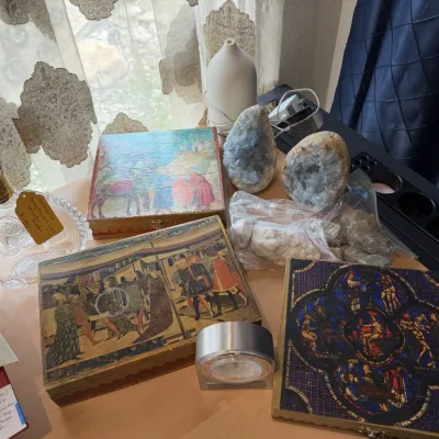 Sale Photo Thumbnail #134: Collection of decorative items including folk art, Florentine style art boxes, raw celestite, and a crystal decanter with stopper.