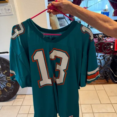 Sale Photo Thumbnail #33: Vintage Wilson Miami Dolphins Dan Marino #13 mesh football jersey in teal with orange and white striping.