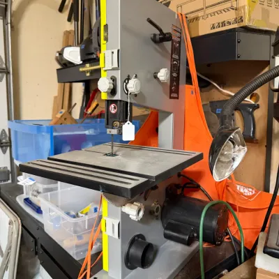 Sale Photo Thumbnail #324: Modern Ryobi desktop band saw with attached task light, in good used condition.