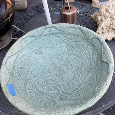 Sale Photo Thumbnail #388: Large light green ceramic birdbath bowl featuring an intricate Escher-style interlocking fish motif. Signed by artist