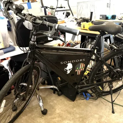 Sale Photo Thumbnail #323: Black Sondors electric bicycle featuring custom skull decals, rear cargo rack, and frame battery compartment.
