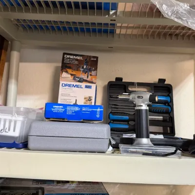 Sale Photo Thumbnail #311: Collection of Dremel tool accessories and hand tools, including a boxed Dremel plunge router attachment (model 335-01), a small butane micro torch, and hard-plastic tool storage cases.