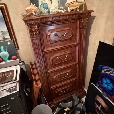 Sale Photo Thumbnail #268: Tall dark wood executive filing chest with fluted columns and brass bail handles, displayed with nautical decor on top.
