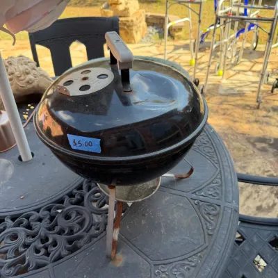 Sale Photo Thumbnail #387: Vintage Smokey Joe black portable kettle grill, showing light wear and minor rust on legs.