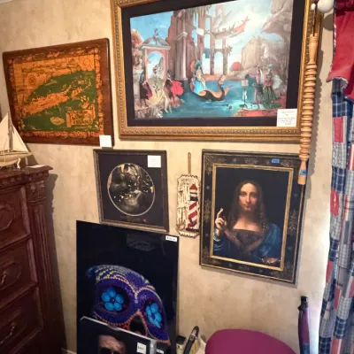 Sale Photo Thumbnail #250: Collection of framed artwork and wall decor, including a reproduction of Da Vinci's Salvator Mundi, a large surrealist canvas art piece, a vintage map of Long Island, and prints.