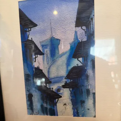 Sale Photo Thumbnail #155: Framed original watercolor painting depicting a European cityscape in shades of blue, signed and dated by the artist at the lower left.