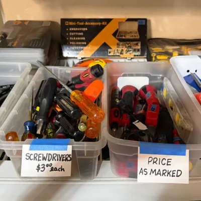 Sale Photo Thumbnail #314: Clear plastic bins filled with assorted hand tools, including screwdrivers, wrenches, and a torpedo level.