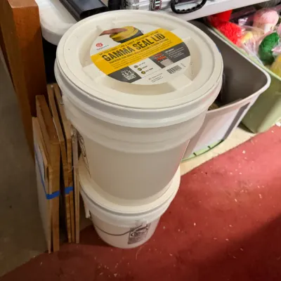 Sale Photo Thumbnail #343: Stacked white plastic 5-gallon storage buckets featuring a screw-top Gamma Seal Lid.