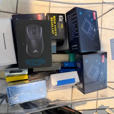 Sale Photo Thumbnail #289: Assorted boxed electronics and gadgets, including gaming mice, hand-held game consoles, and headlamps.