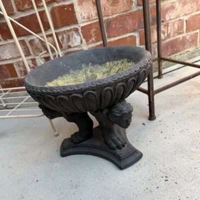 Sale Photo Thumbnail #393: Garden planter urn with classical cherub or winged figure supports and weathered dark finish.