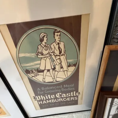Sale Photo Thumbnail #236: Framed vintage-style White Castle Hamburgers advertising print, featuring a 1920s-1930s illustration of a young couple.